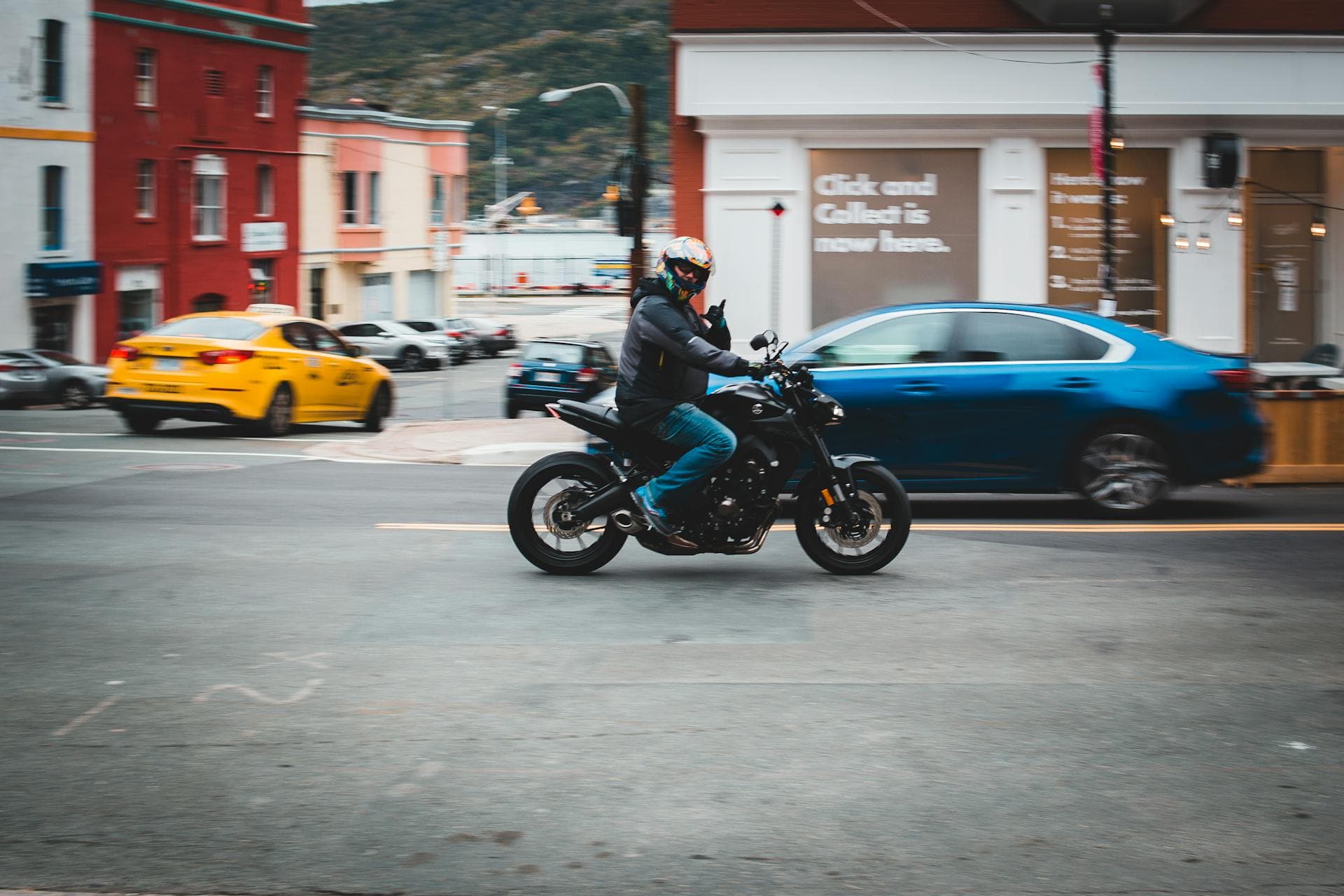 A motorcyclist riding a bike through city traffic